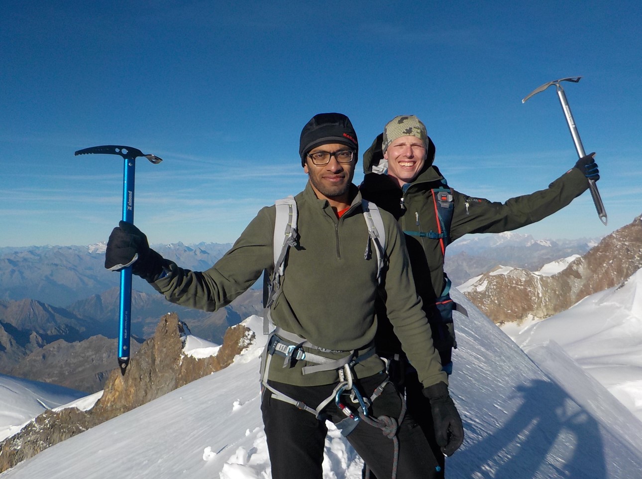 Roped climbers on a snow ridge in the Monte Rosa massif